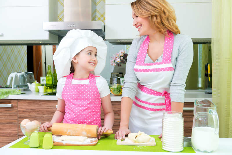 小女孩和母亲在厨房对视而笑