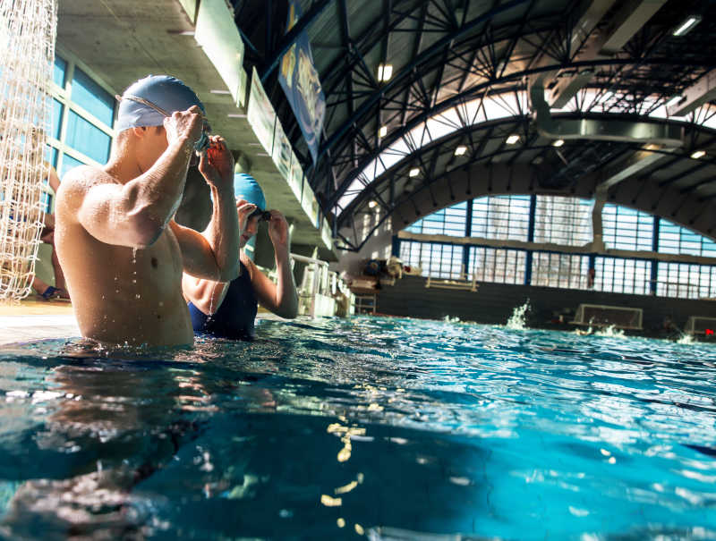 蓝色游泳池里浮出水面的游泳者