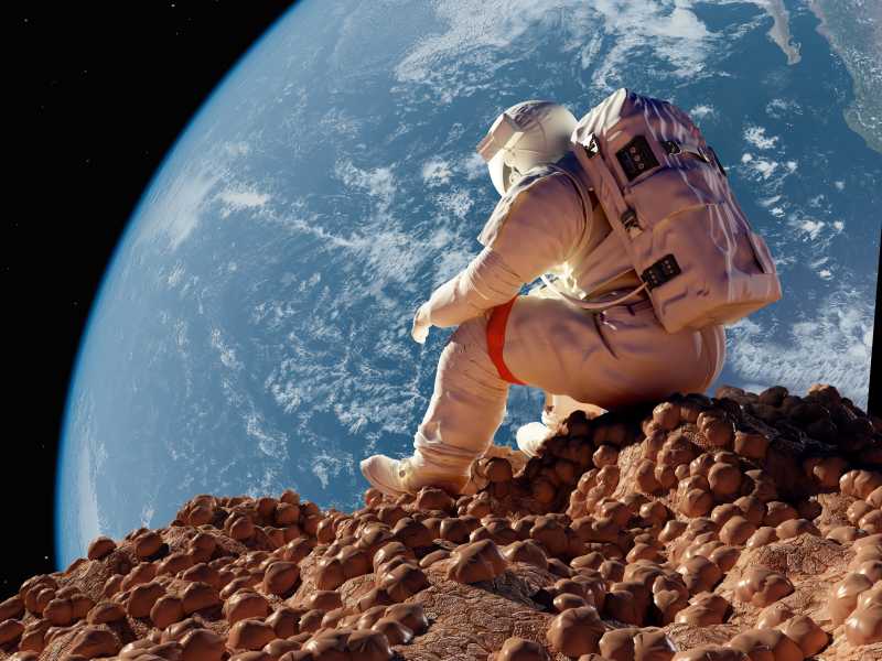 坐在外太空的望着地球的宇航员