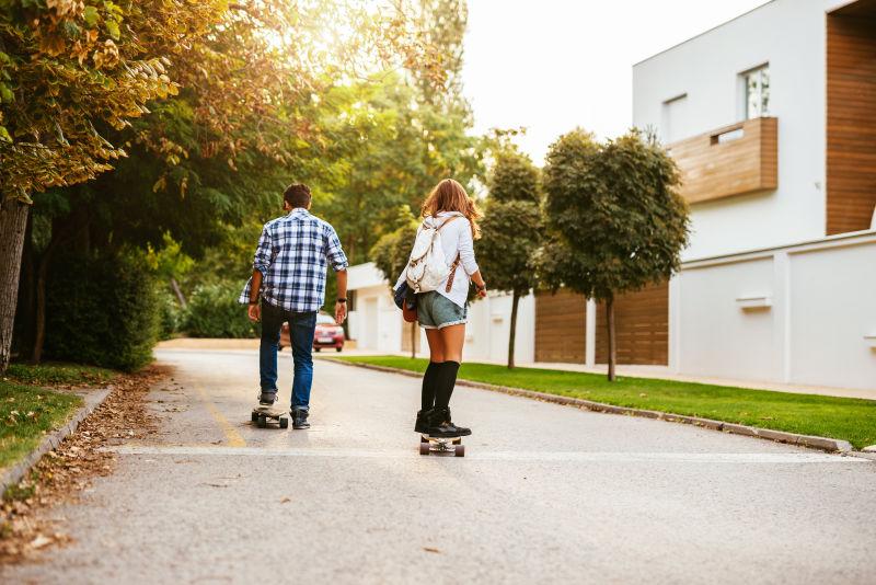 享受阳光的练习滑板的情侣