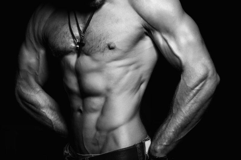 黑色背景下拥有完美肌肉身材的男人