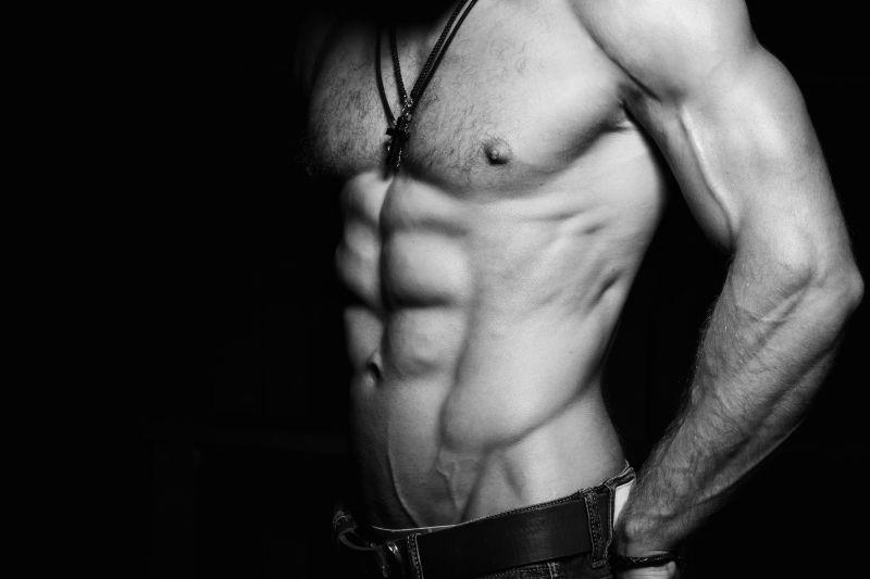 黑色背景下的拥有完美肌肉的健身男士