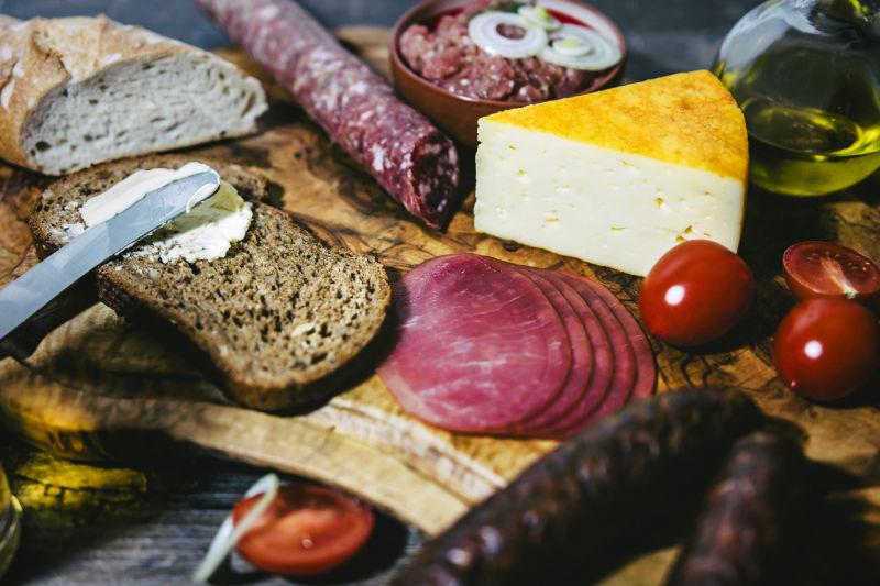 木砧板上的各种面包香肠和奶酪