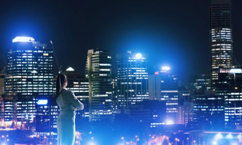 优雅的白衣商人看着美丽的城市风景