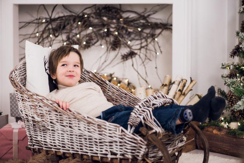 躺在竹椅上微笑的男孩