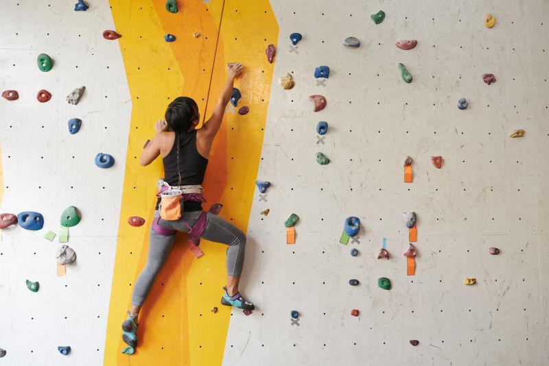 室内攀岩墙上的攀岩者