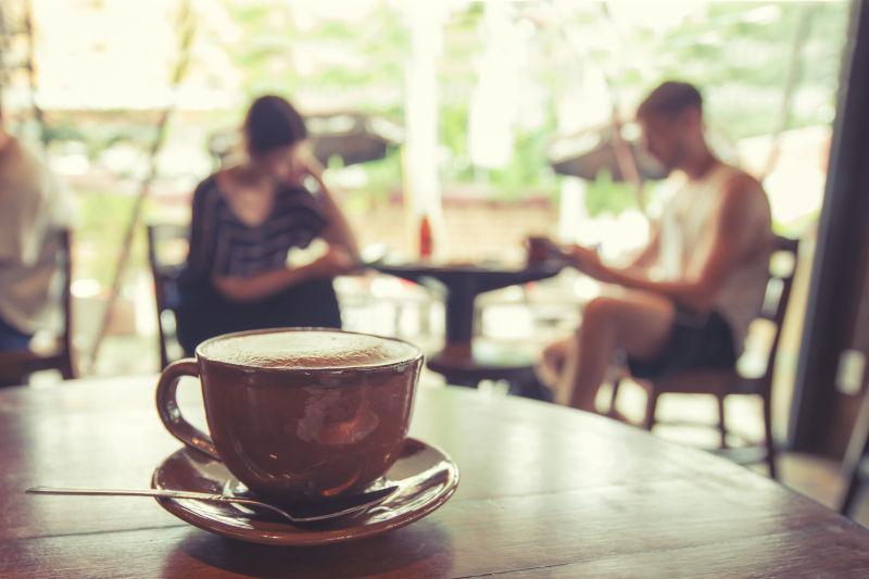 咖啡桌上的咖啡杯与两个人