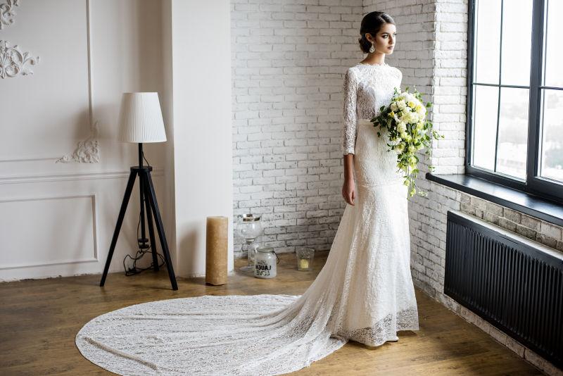 手持花束的新娘穿着美丽的婚纱