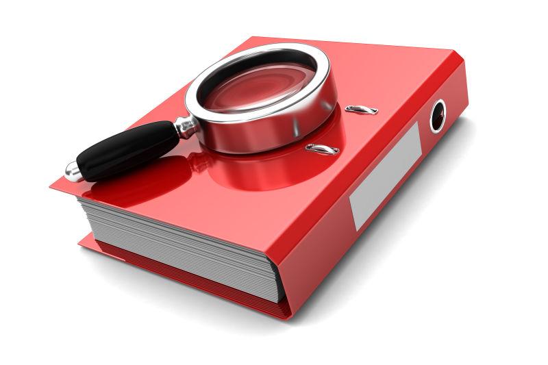 红色文件夹上放着一个放大镜