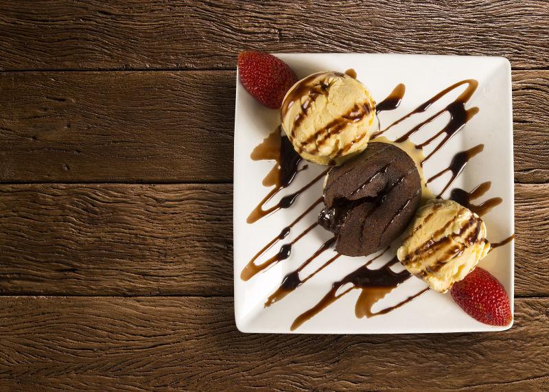 桌面上的白色盘子里放着美味的冰淇凌球