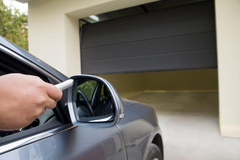 车里男人用车库遥控器打开车库门