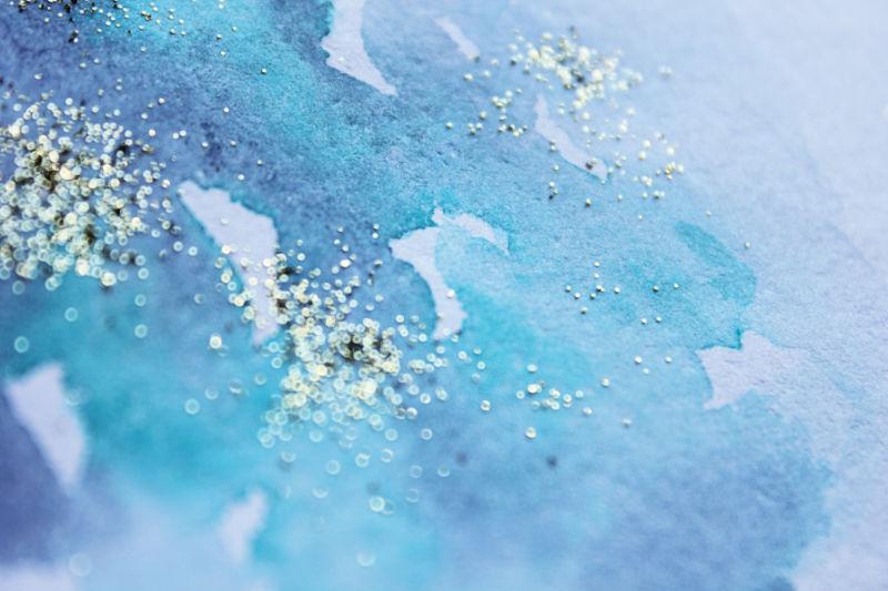 蓝色撒有金粉的水墨背景