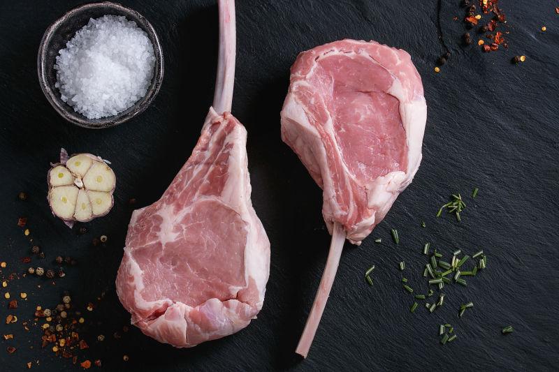 黑色背景中的生牛肉和烹饪香料