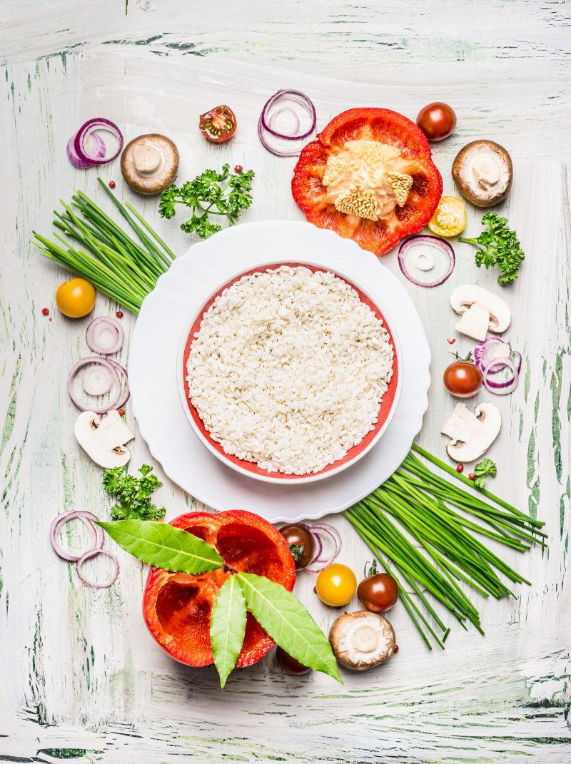 老旧白色桌上的洋葱圈和彩椒和米饭的晚餐