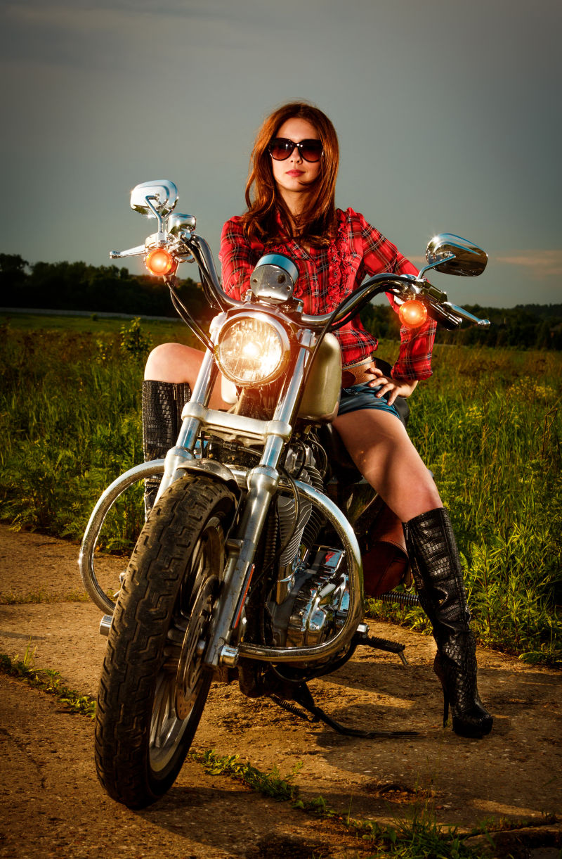 戴太阳镜的女子骑着摩托车