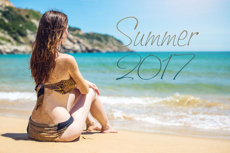 坐在沙滩上眺望大海的女人