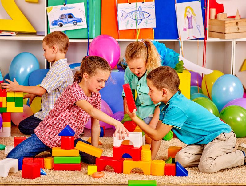 幼儿园的孩子们在地板上搭积木