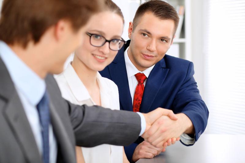 The meeting finished. Two businessmen hand to hand. 2 Businessmen meet each other.