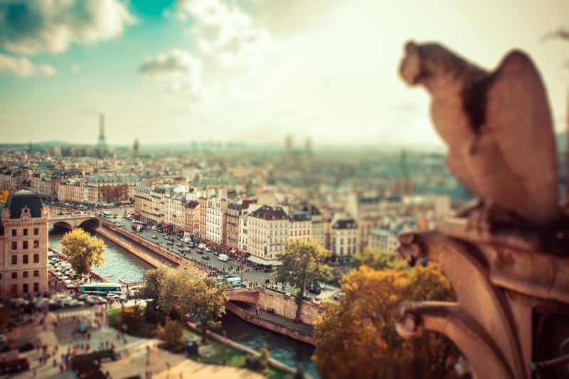 蓝天白云下巴黎石像旁的城市景色