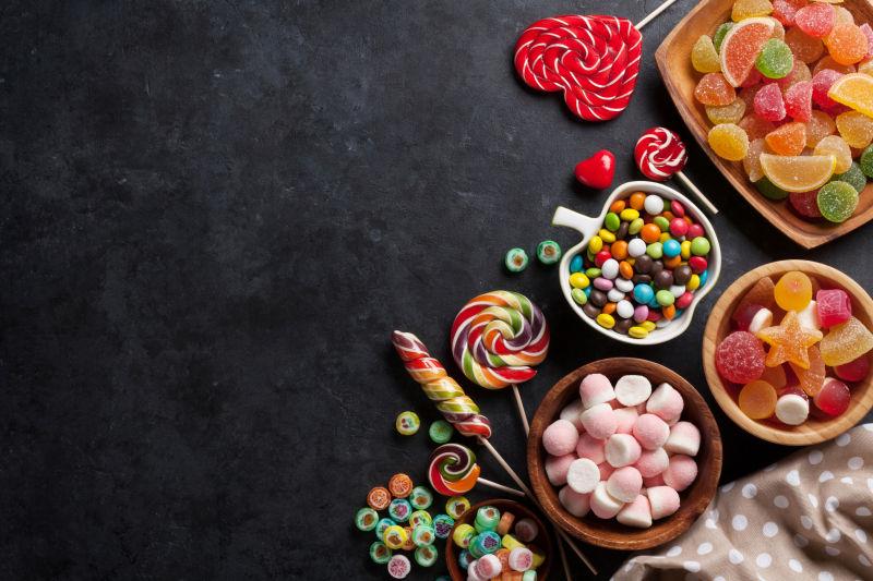 桌面上装着不同种类糖果的碗碟