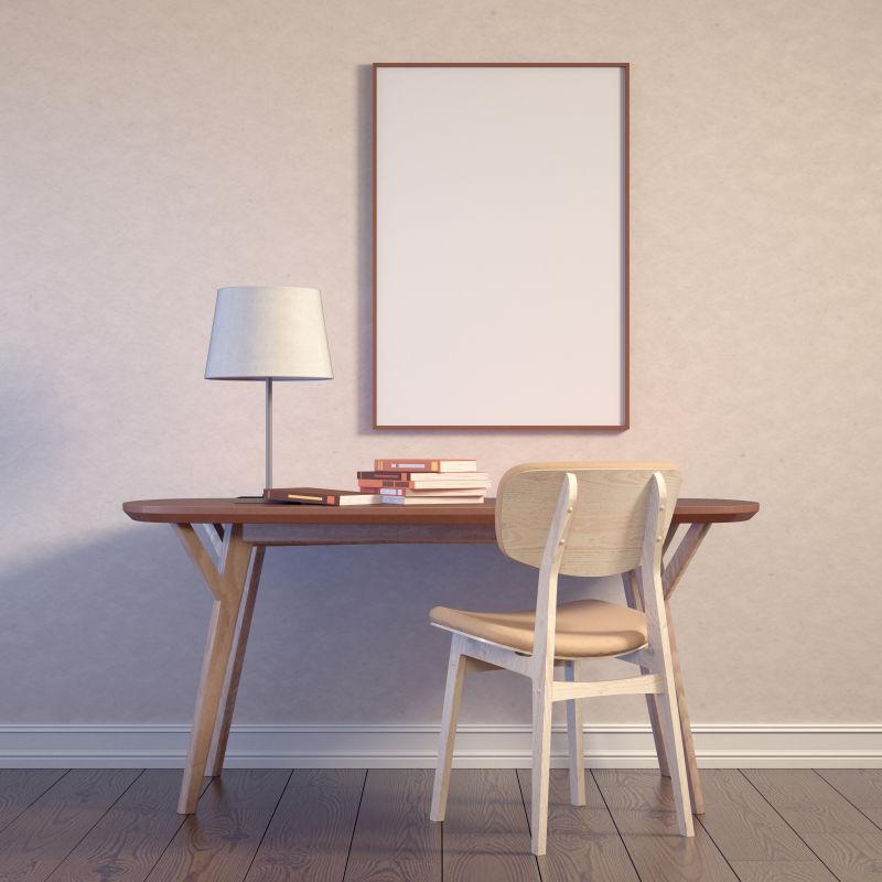 地板上放着书的桌子和墙壁上的白色画框