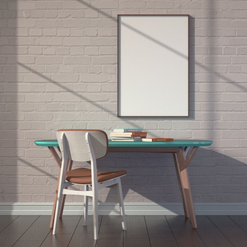 地板上的绿色椅子和砖墙上空白画框