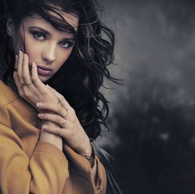 暗色背景上一个年轻女人的艺术写真