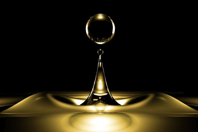 黑暗中的金黄色水滴波纹