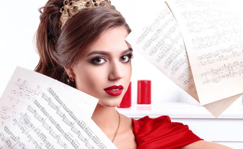 白色背景中拿着乐谱的红衣女孩