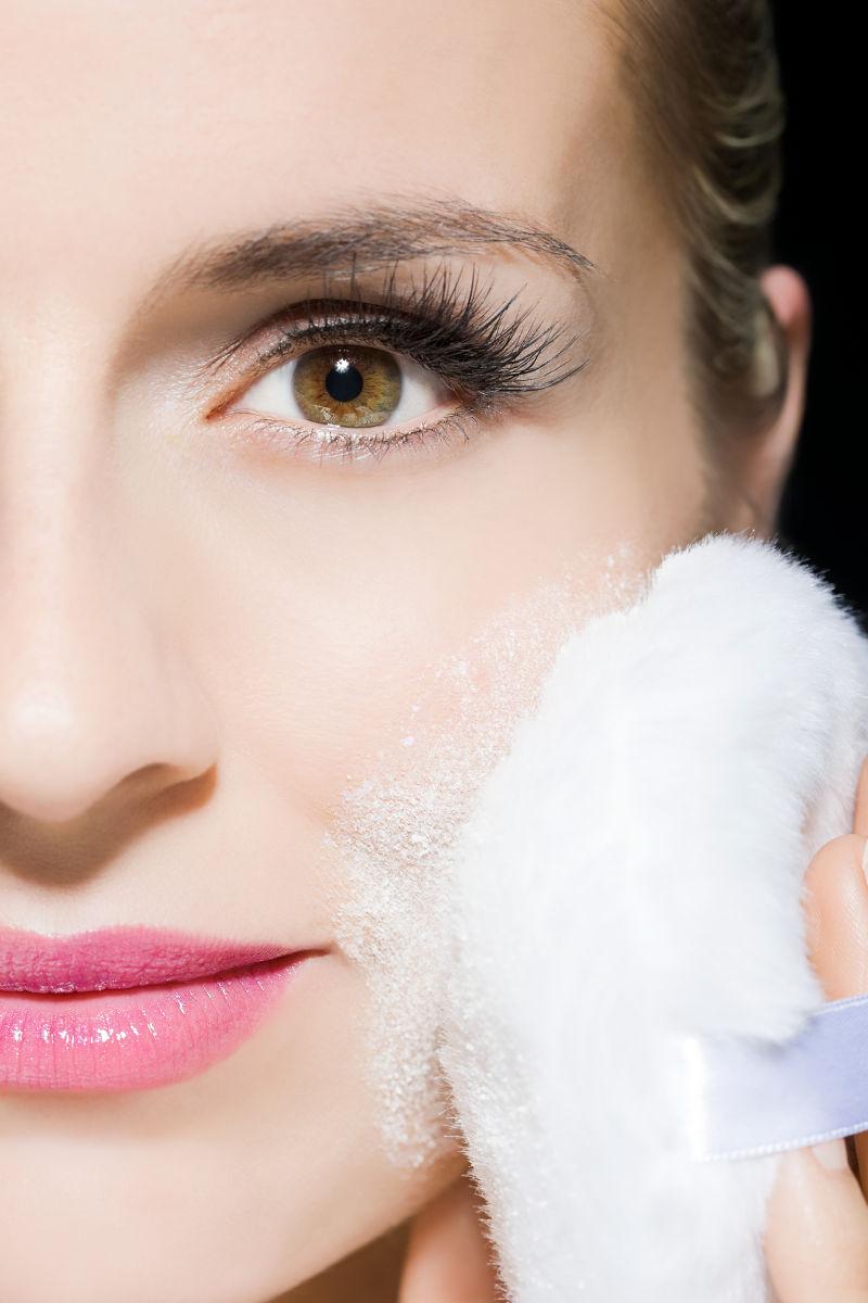 女子微笑着敷面粉