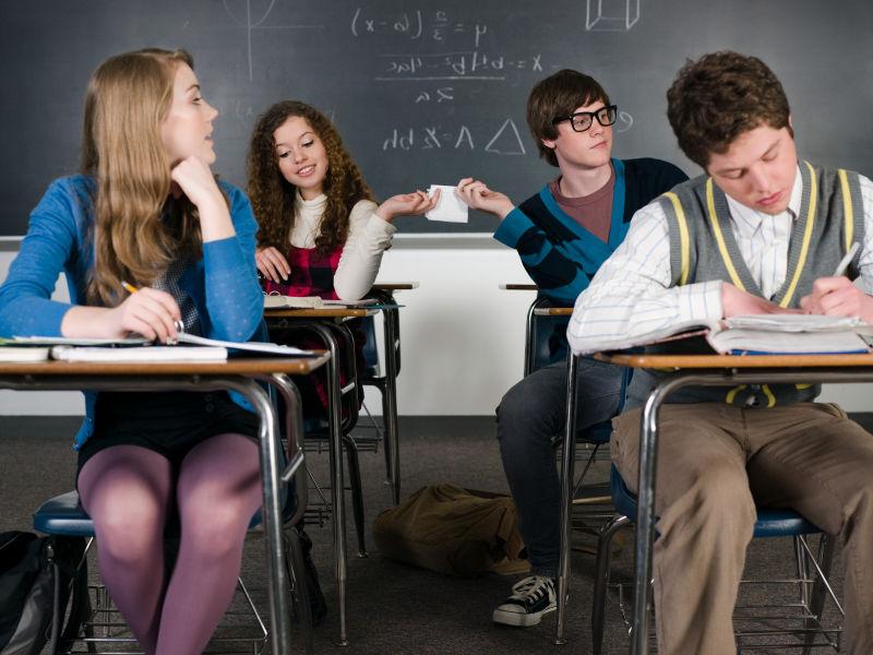 在课堂上传递笔记的男女