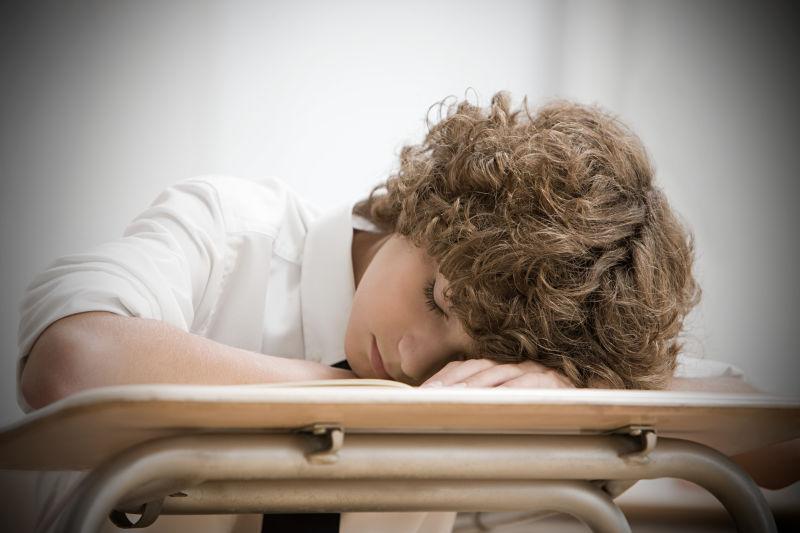教室里睡着的男孩学生