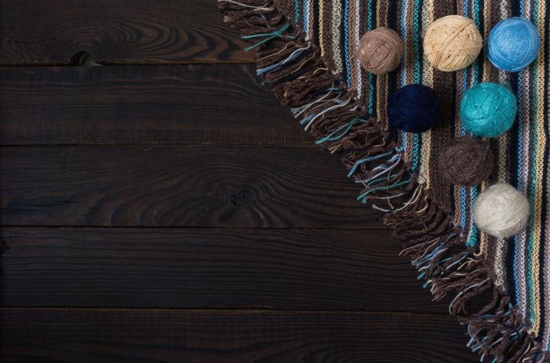 针织针和暗木表面上的纱线球