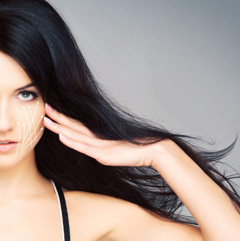 灰色背景上一个脸上画着箭头的长发美女