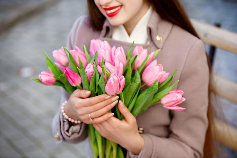 微笑的美女与郁金香花束