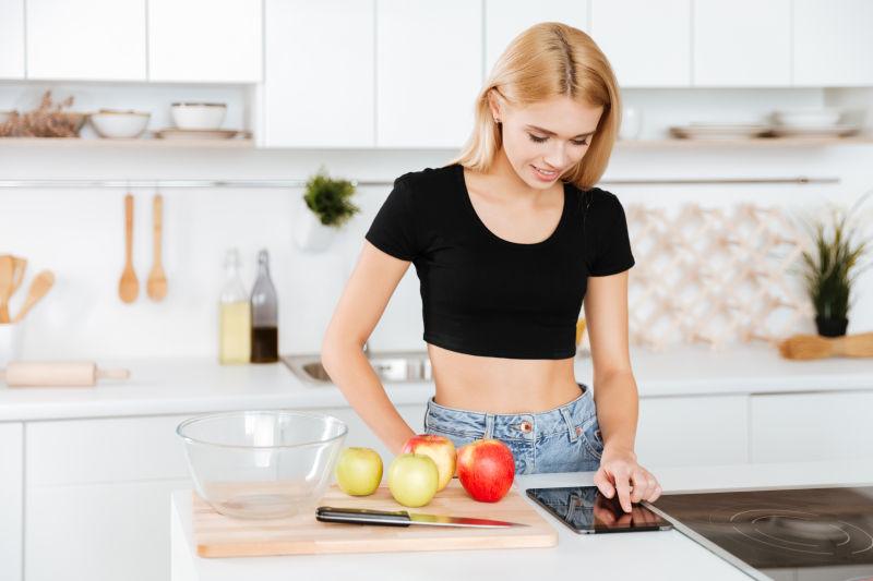 厨房里使用平板电脑的女人