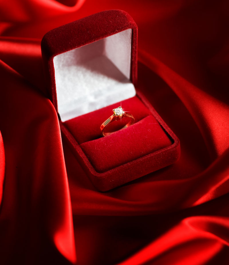 红色背景中钻石戒指