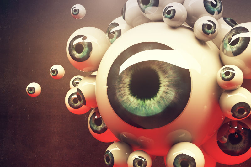 暗色背景上不同尺寸的绿色眼珠特写镜头