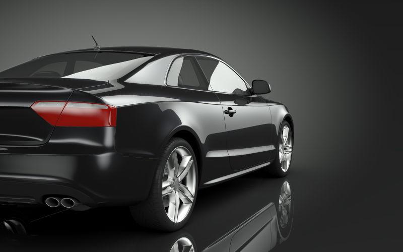 黑色背景下一辆黑色的豪华轿车