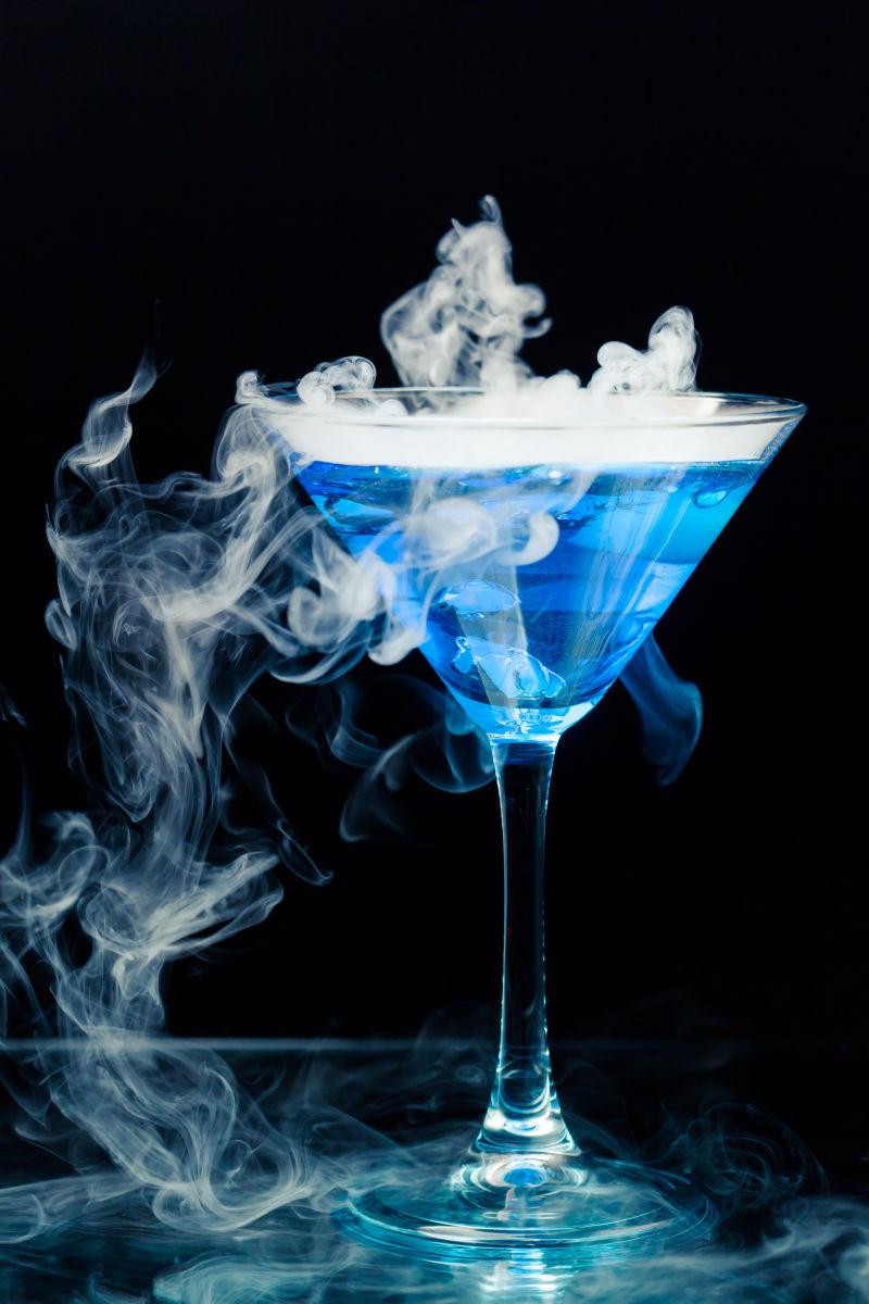 带有飞溅和冰蒸气的蓝色鸡尾酒