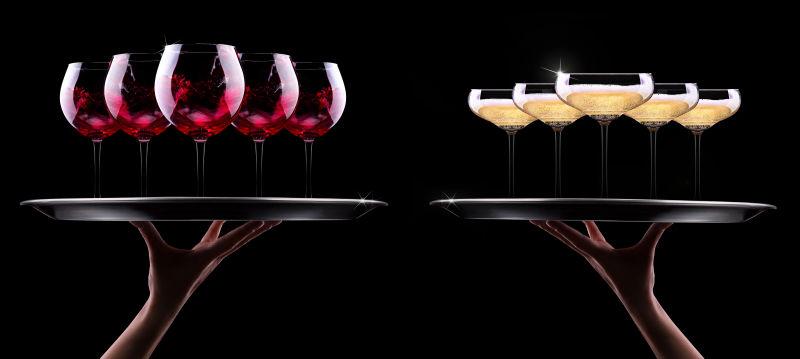 侍者手拿香槟酒和黑色背景酒