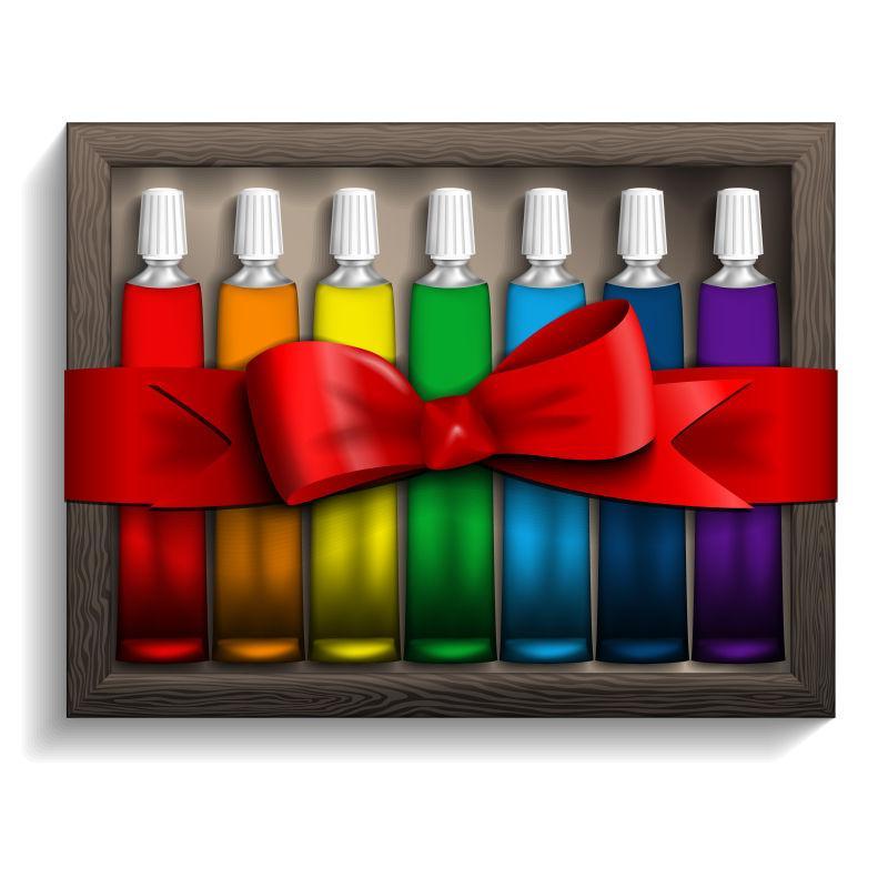 白色背景上的放在盒子里扎好的彩色颜料