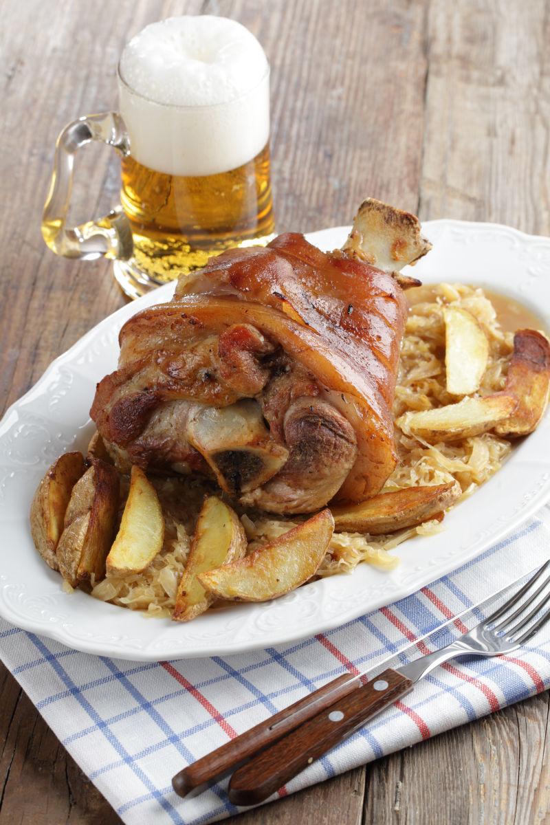 烤猪蹄配蔬菜和啤酒