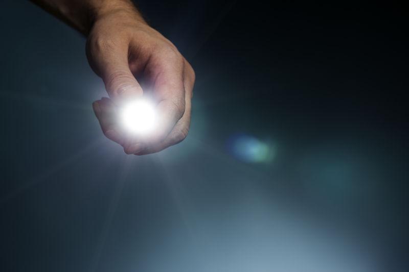 男人手里的强光手电筒