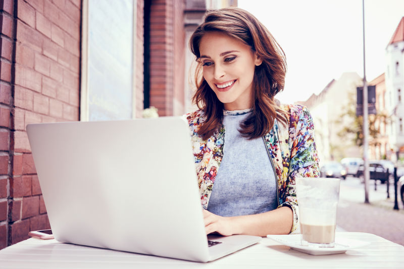 美女微笑的使用笔记本电脑