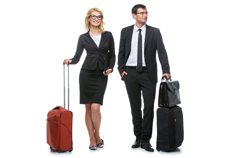 带着手提行李旅行的箱子的男女商人