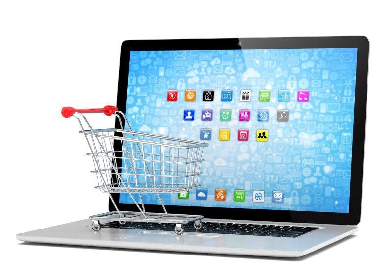 白色背景下笔记本上的微型购物车