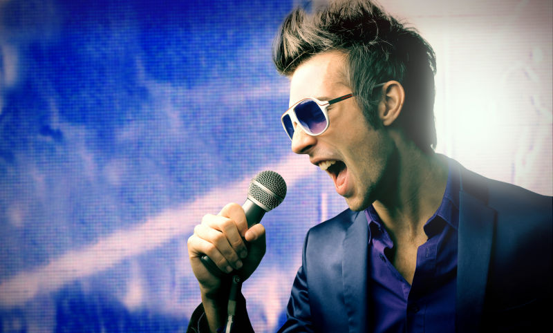 时尚的男歌手正在唱歌