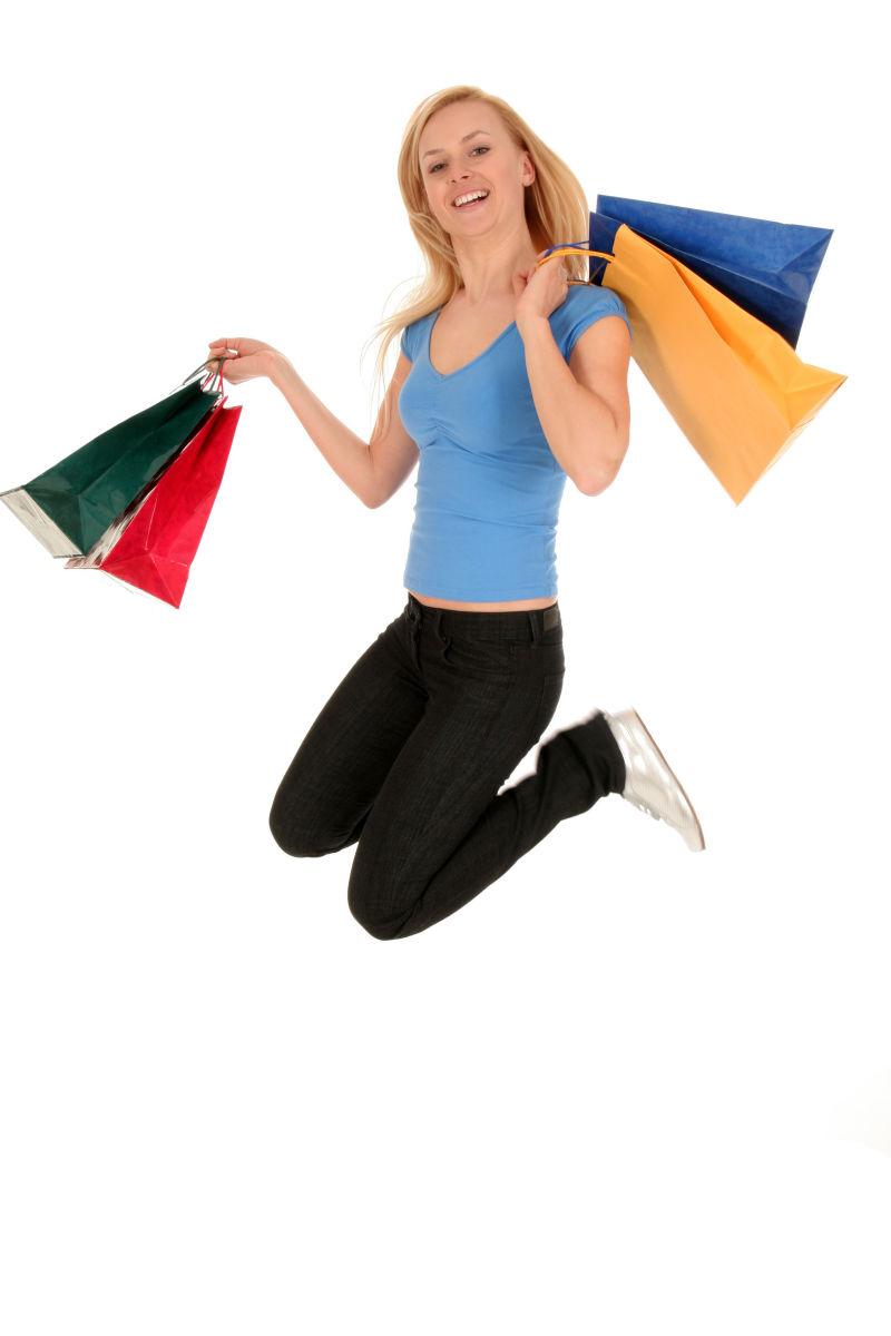 女人用购物袋跳跃