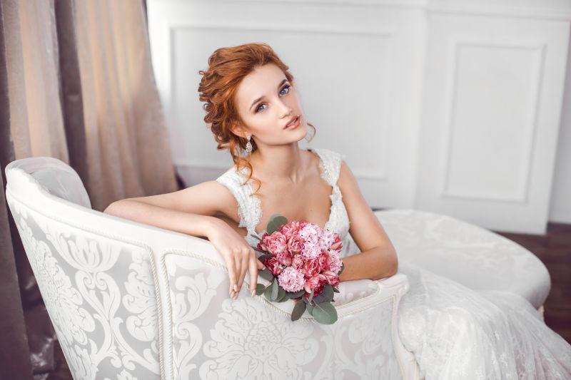 穿着漂亮衣服的新娘坐在沙发里